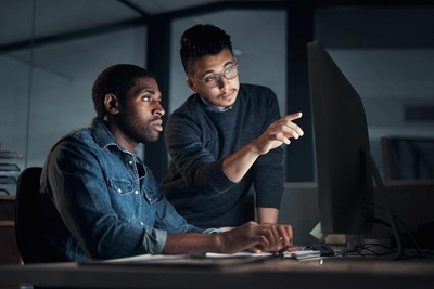 Two male coworkers at computer