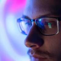 Man Watching Computer Through Glasses
